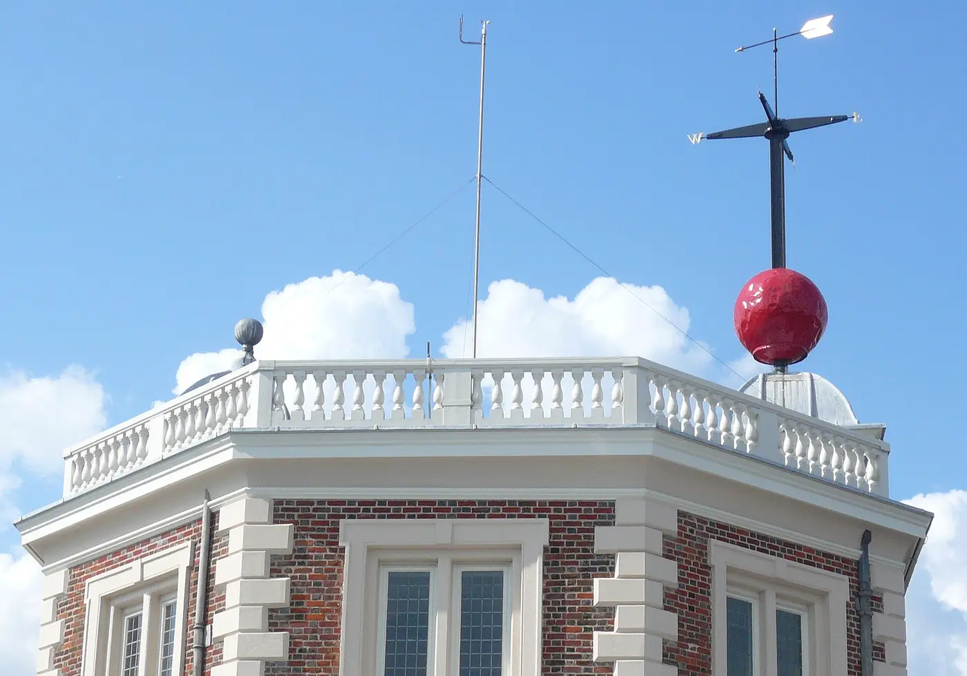 A red time ball on its mast above the octagonal turret of the Royal Observatory