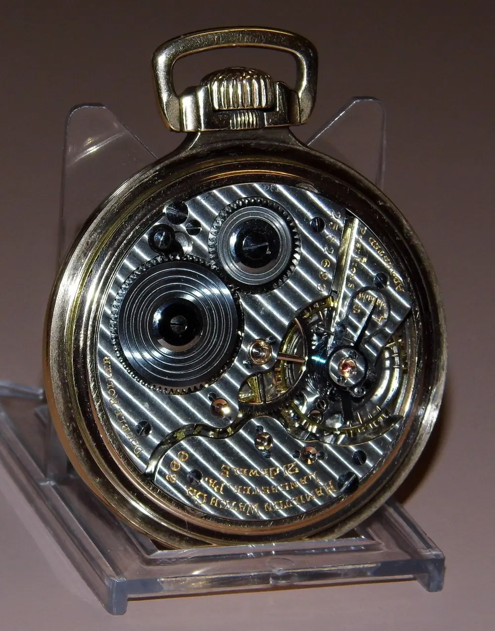 The open back of a railroad-grade pocket watch, showing its jewelled movement